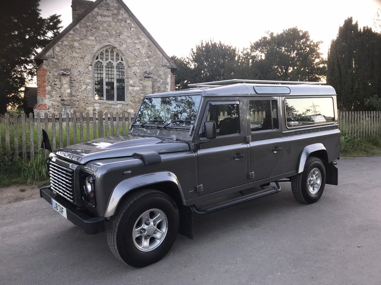 Terry Allen Land rover parked on country road outside village church