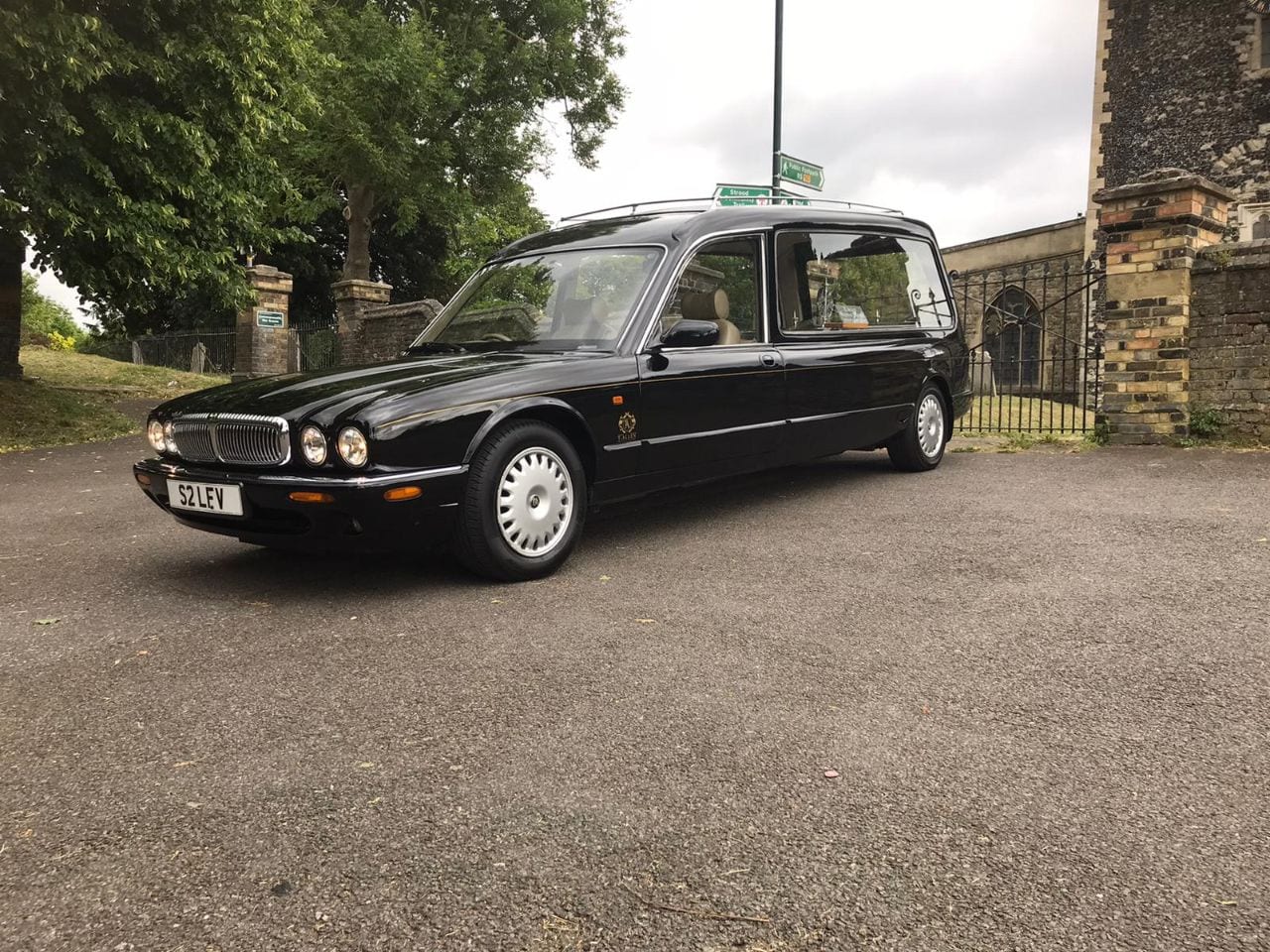 Traditional style Terry Allen funeral car parked outside of church